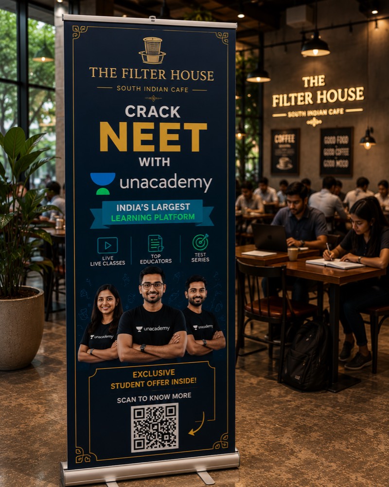 Concept mock-up: a roll-up standee in a cafe seating area, advertising an online learning platform with a QR code.